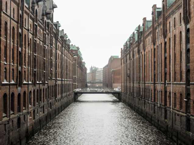 The Frankfurt city surrounded by buildings under a cloudy sky during a golden sunset in Germany
