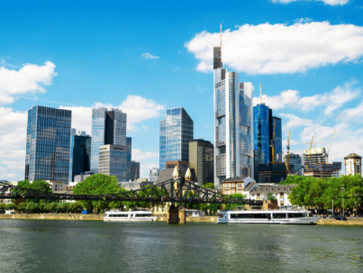 The Frankfurt city surrounded by buildings under a cloudy sky during a golden sunset in Germany