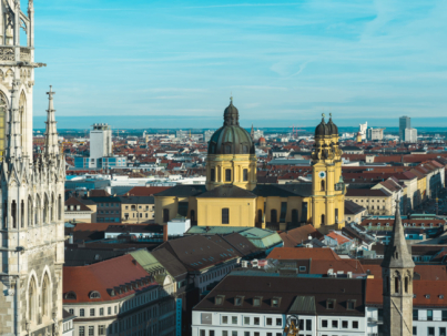 The Frankfurt city surrounded by buildings under a cloudy sky during a golden sunset in Germany