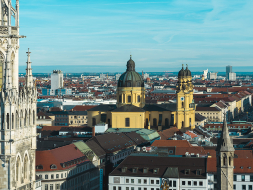 The Frankfurt city surrounded by buildings under a cloudy sky during a golden sunset in Germany